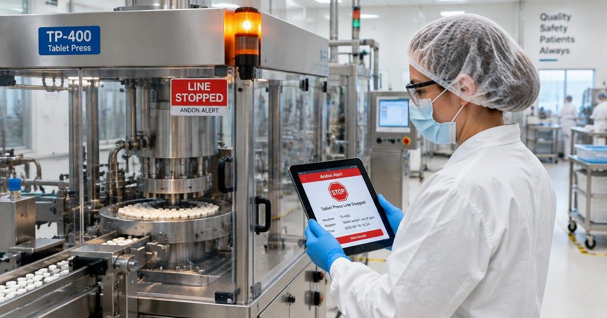 Jidoka: an operator in hairnet, mask, glasses and gloves checks a stop alert on a tablet after the tablet press andon light halts the line
